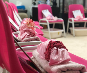 pink chairs with towels and robes for pamper party