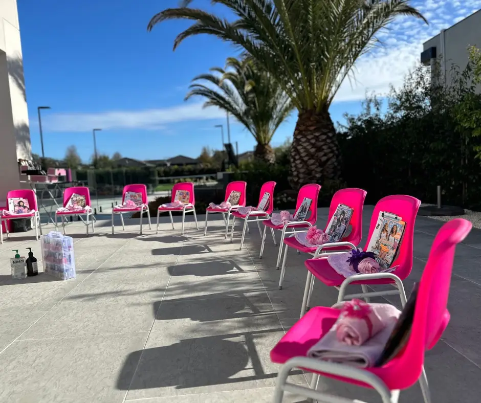 pink chairs set up outdoors with nice scenery for a pamper party