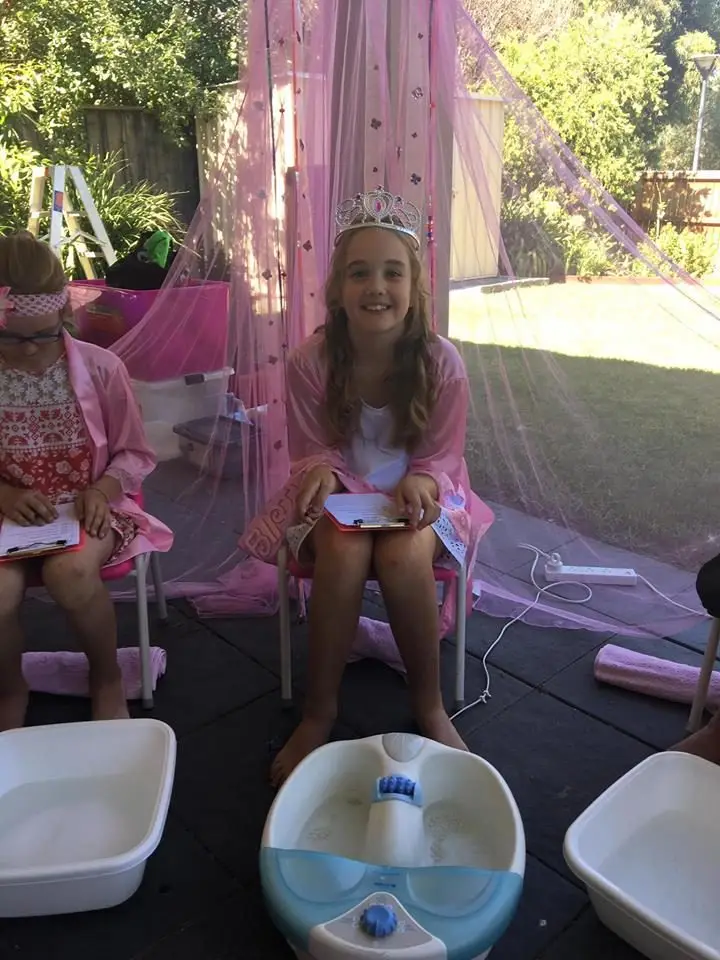 girl with crown and pink robe for foot spa