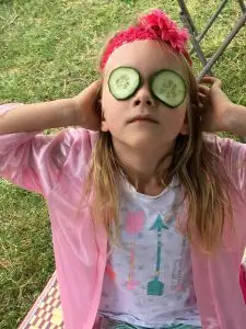 girl in pink robe with cucumber eyes