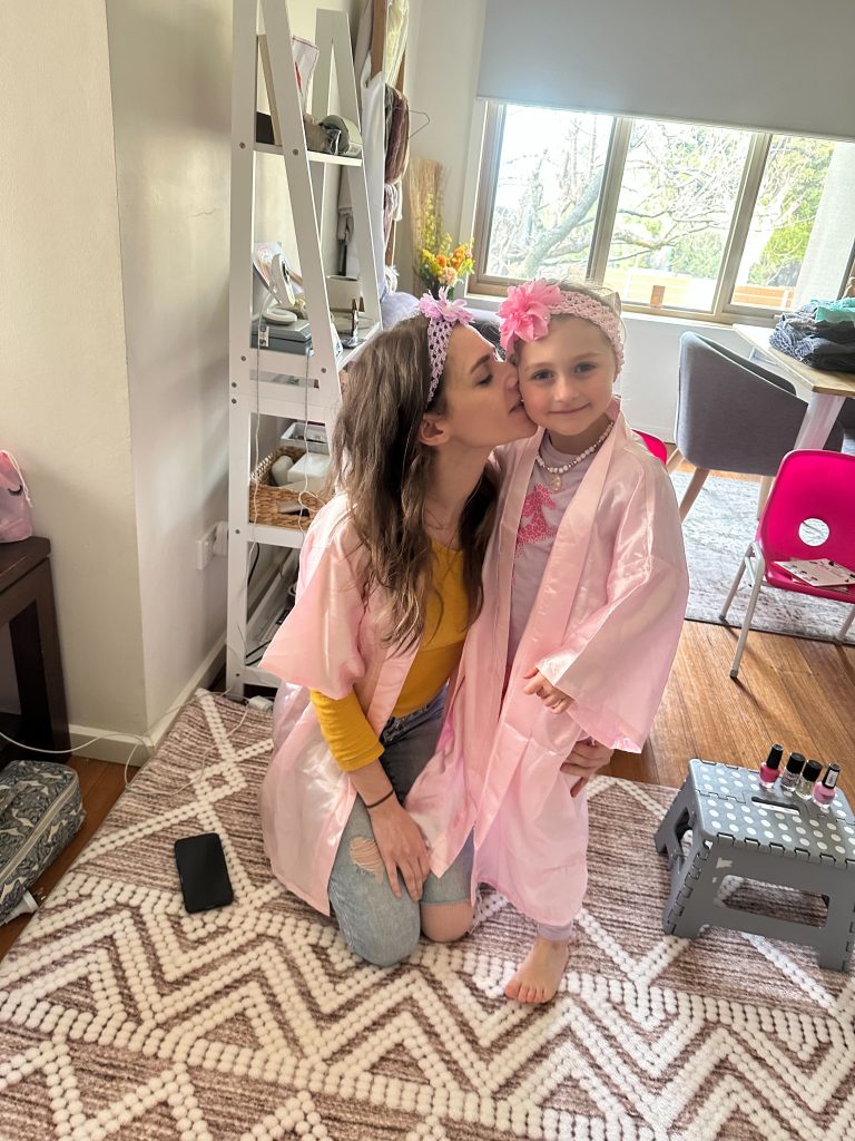 mum kisses daughter at pamper party